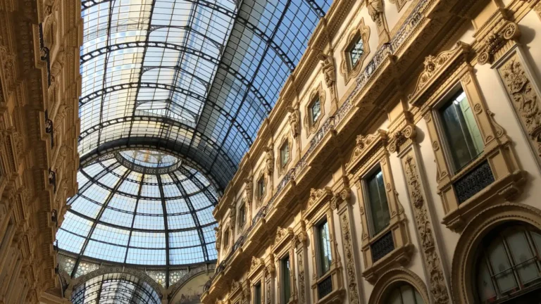 Glass-domed Italian gallery with ornate facades seen from below