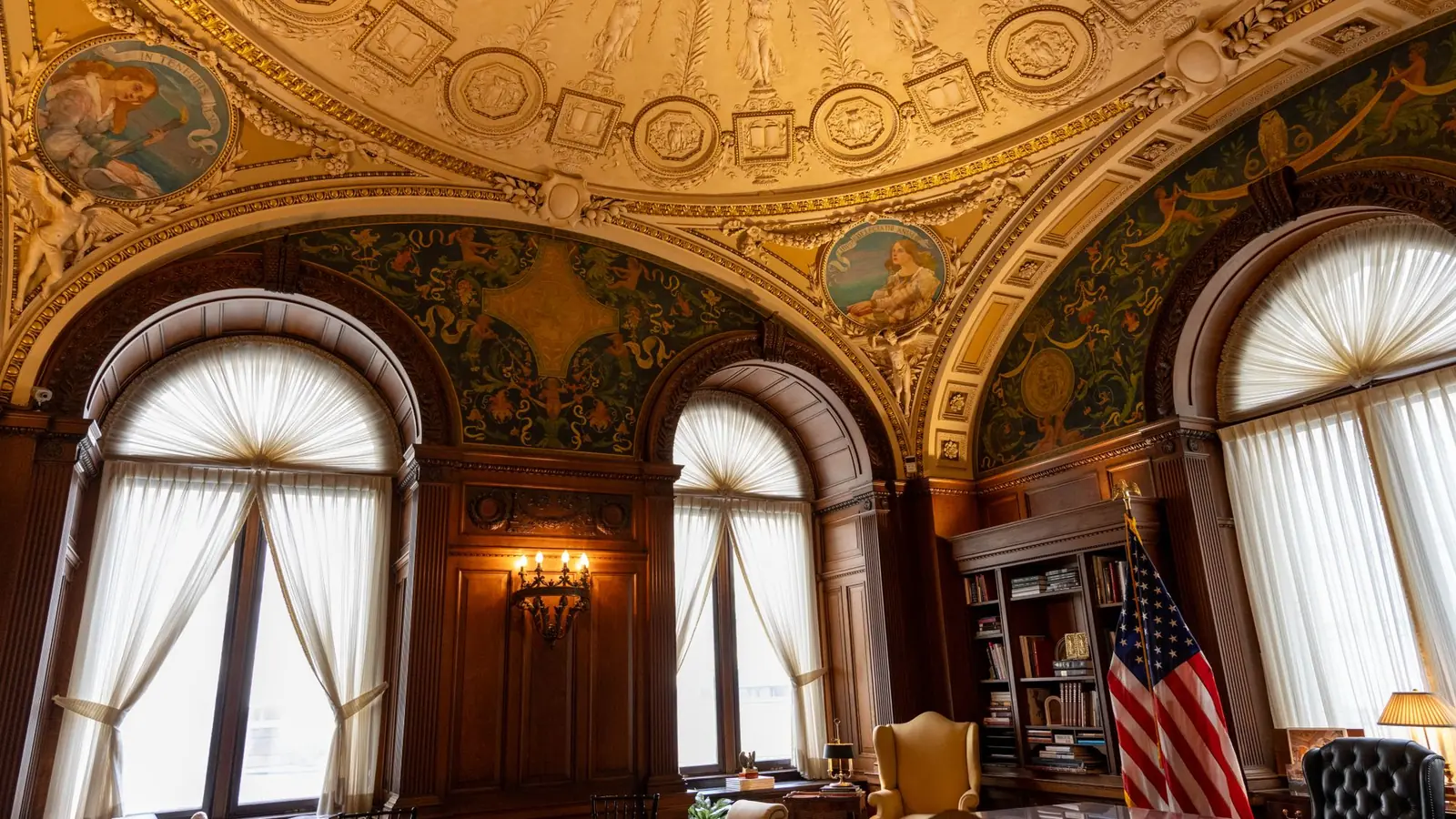 Paneled study with a frescoed gilded ceiling and tall arched windows