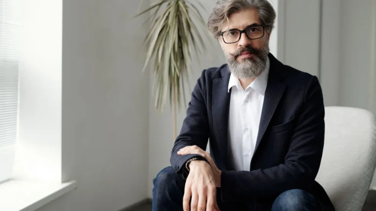 Practice owner in a suit seated in a bright office, ready to discuss AI search visibility