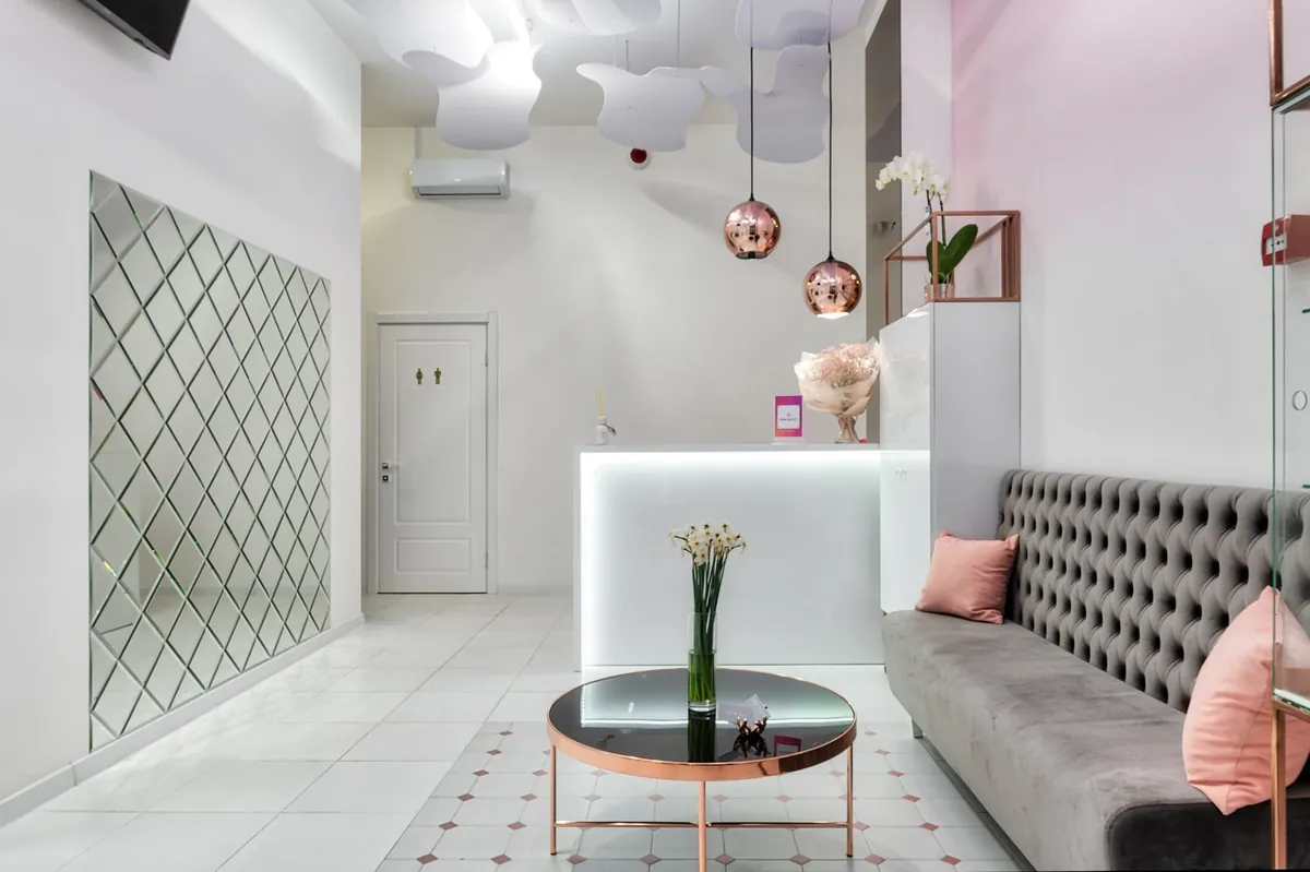 Contemporary reception lounge with sofa, table and modern lamps