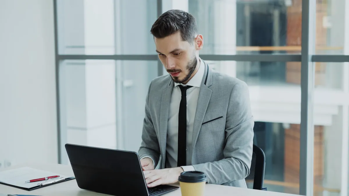 Professional working on a laptop in a modern office setting