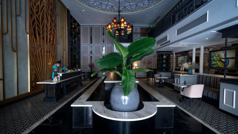 Luxury lobby with black marble floors, a reception desk and an orchid centerpiece