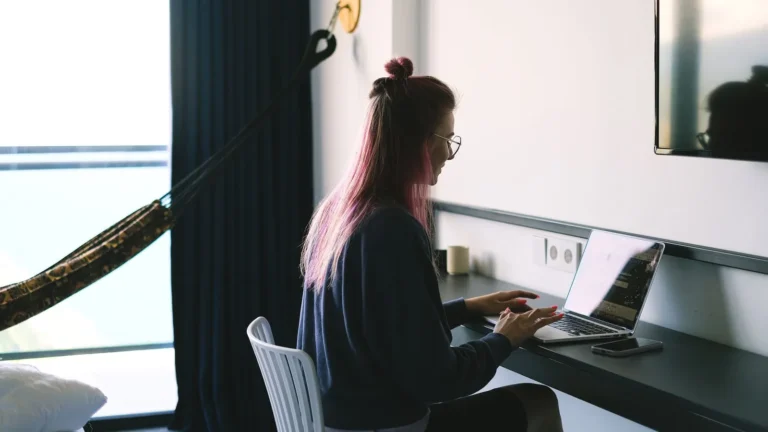 Marketing lead working on a laptop in a stylish home office, reviewing email settings