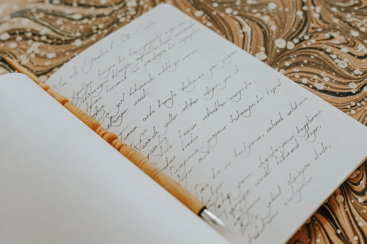 Handwritten notes on an open notebook resting on gold brocade
