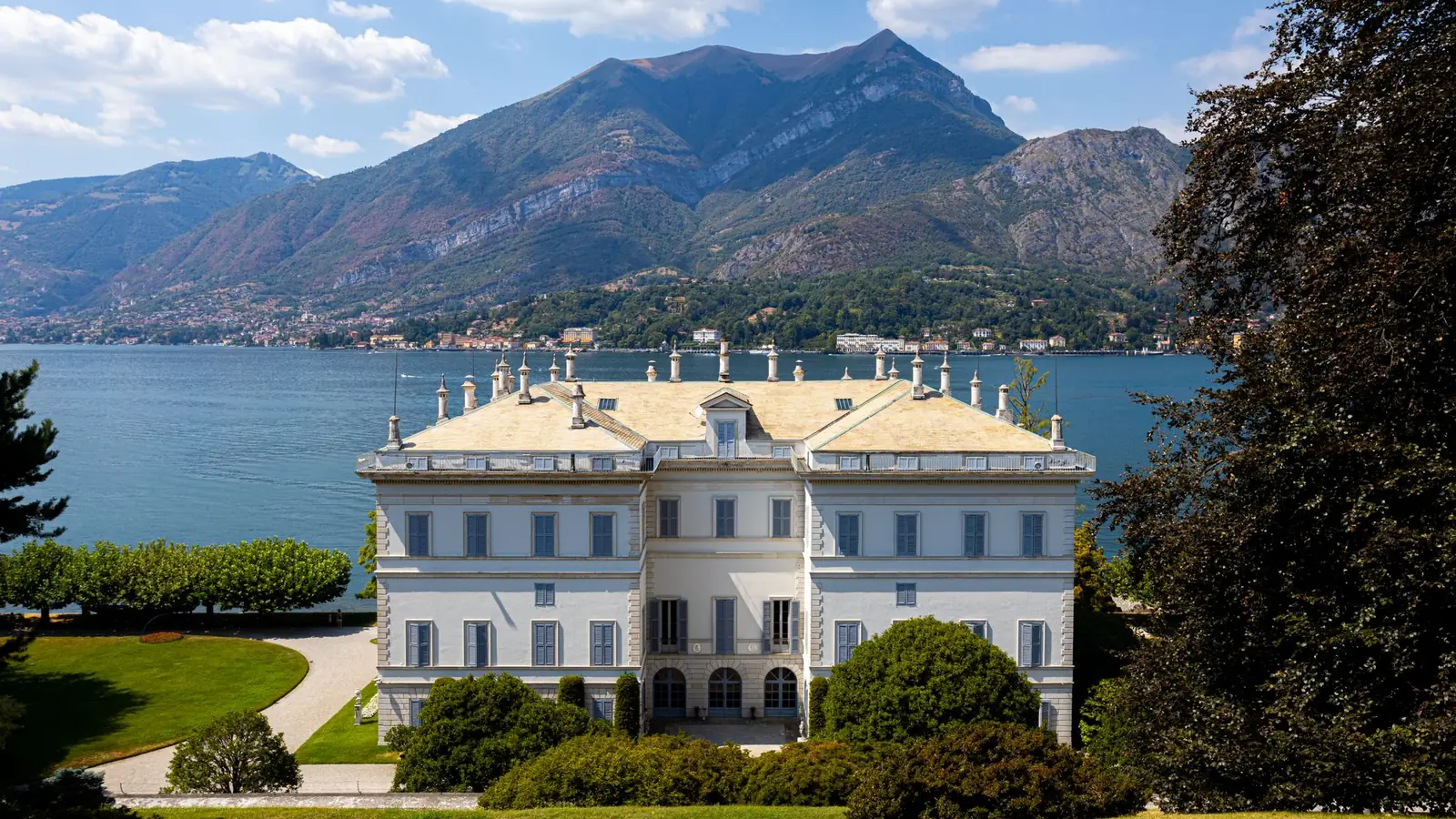 Lakeside Italian villa with mountains behind and formal lawns