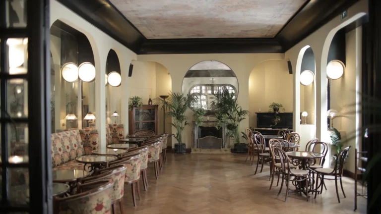Art deco cafe with arched mirrors, globe sconces and bentwood chairs