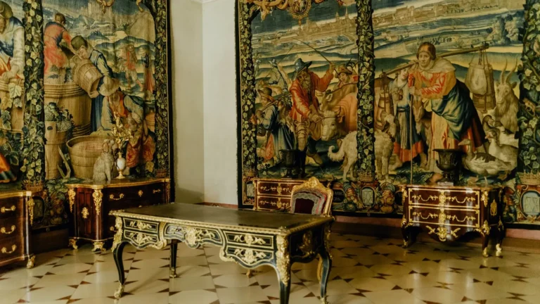 Renaissance tapestry room with a gilded writing table on a marble floor