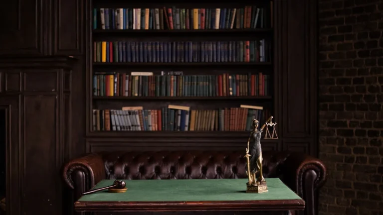 Dark library with a green leather desk and tall bookshelves