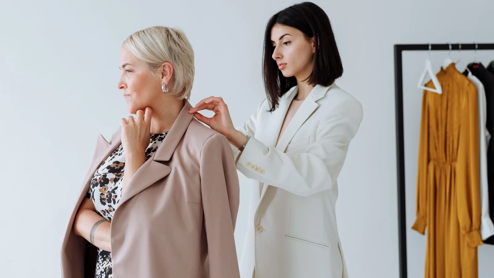 Consultant in a white suit advising a client in a modern studio