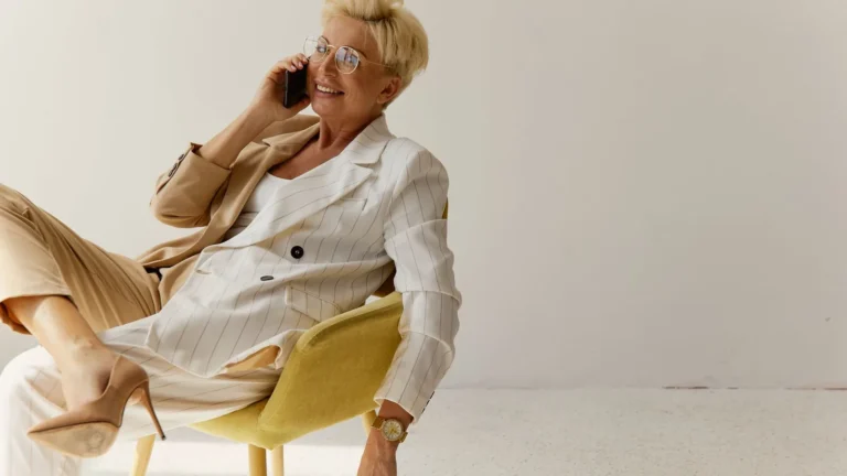 Professional in a white suit taking a call on her smartphone