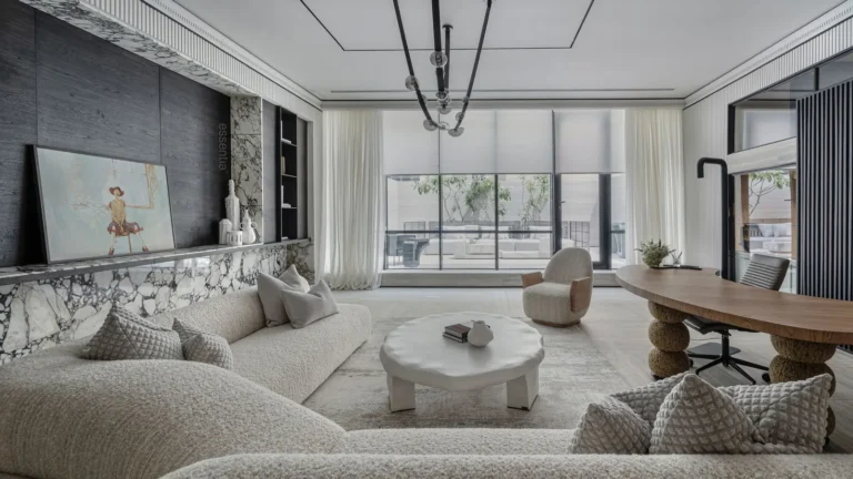 Spacious modern lounge with soft sofas, round tables and a large window