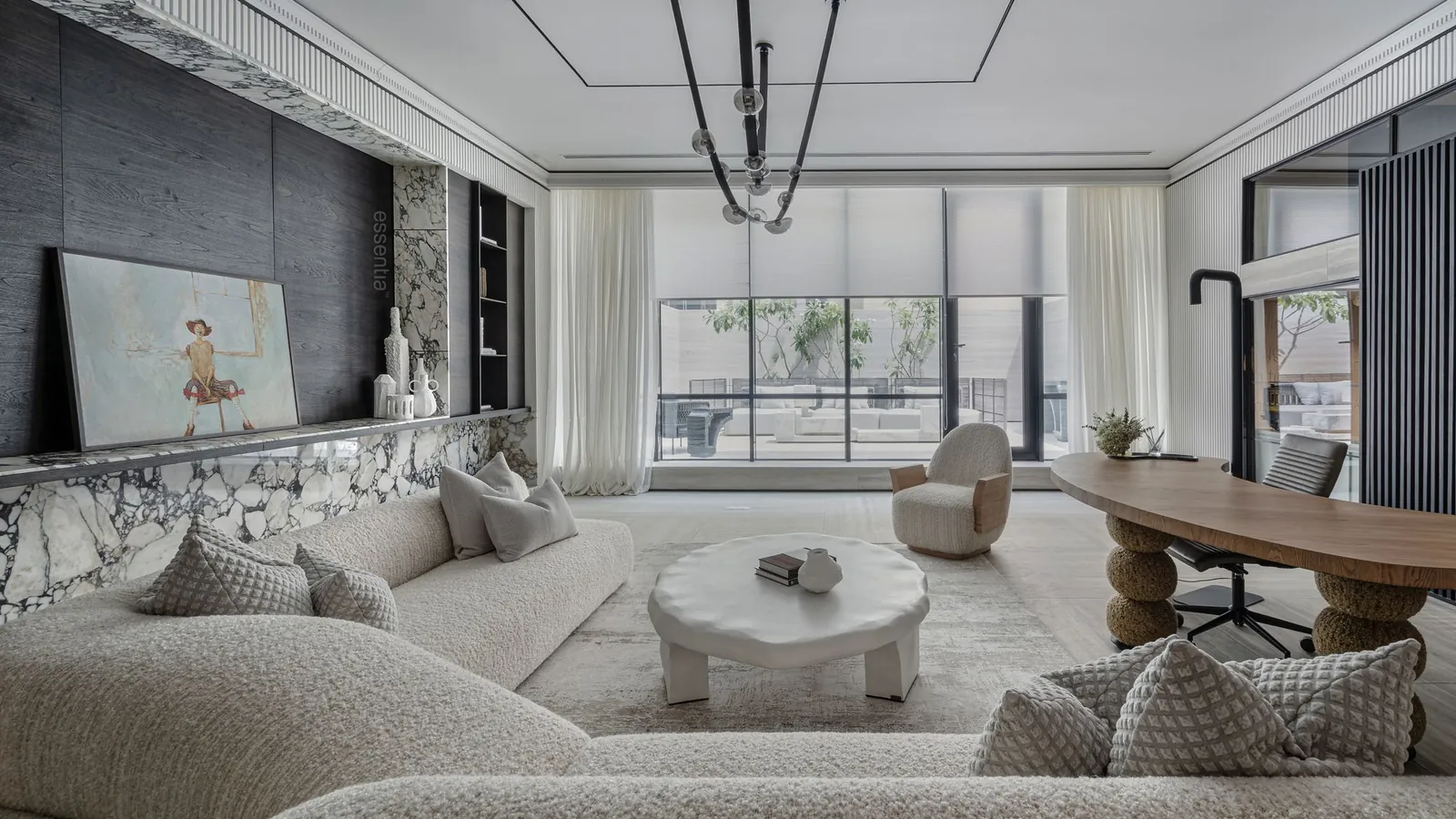 Spacious modern lounge with soft sofas, round tables and a large window
