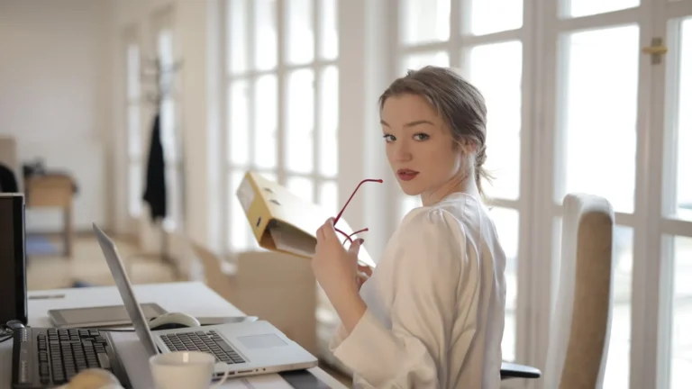 Clinic owner working through paperwork at a table in a modern workspace