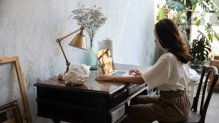 Practice manager reviewing website privacy settings on a laptop at a wooden desk