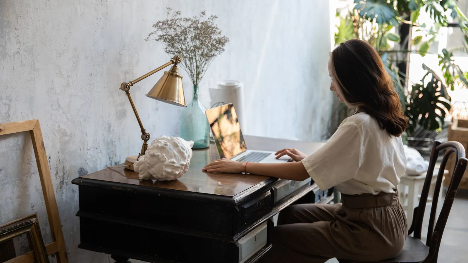 Practice manager reviewing website privacy settings on a laptop at a wooden desk